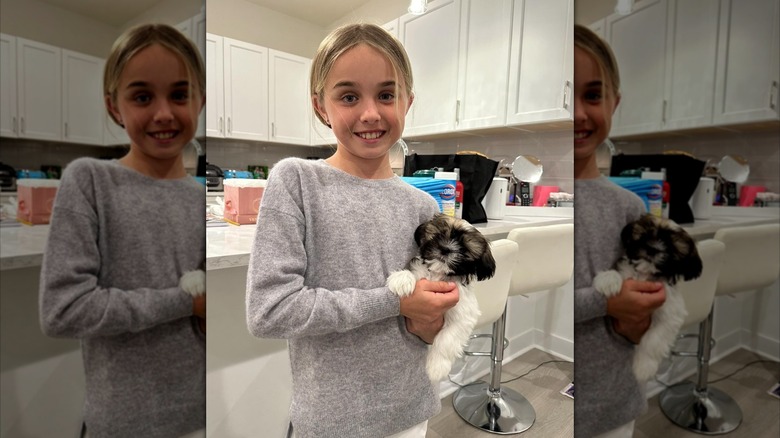 Chloe Sophia Trump smiling and holding a puppy