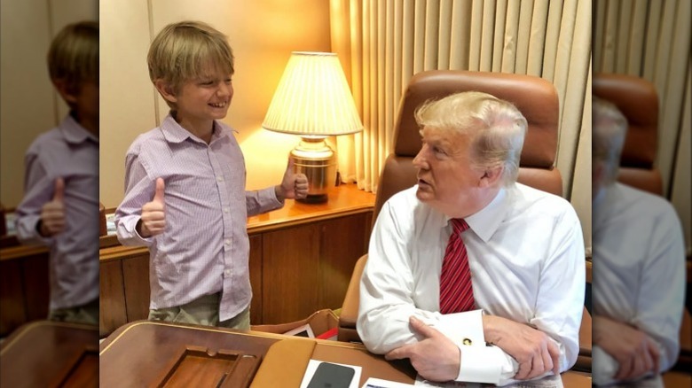 Tristan Milos Trump giving Donald Trump a double thumbs up aboard Air Force One