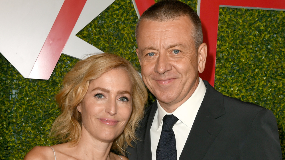 Gillian Anderson and Peter Morgan smiling