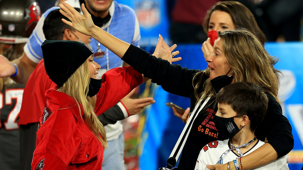 Camille Kostek and Giselle Bündchen getting ready to hug