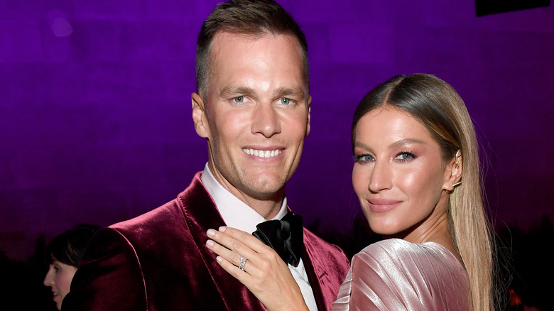 Gisele Bündchen holding Tom Brady red jacket