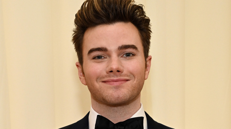 Chris Colfer pompadour hair mustache 5 o'clock shadow, smiling