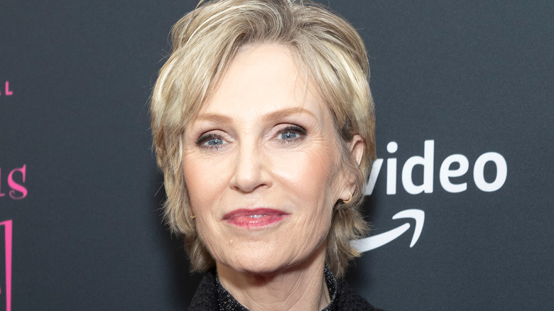 Jane Lynch blonde hair closed mouth smile pink lips