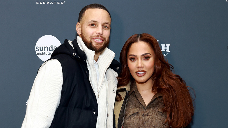 Stephen and Ayesha Curry posing for pictures