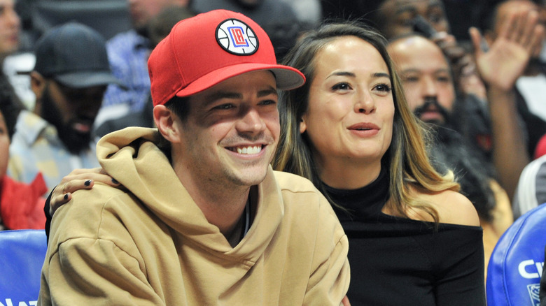 Grant Gustin and LA Thoma smiling together, seated