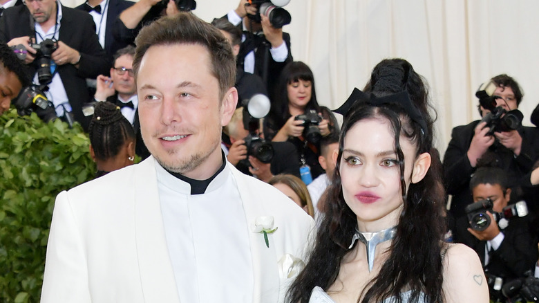 Elon Musk and Grimes smiling