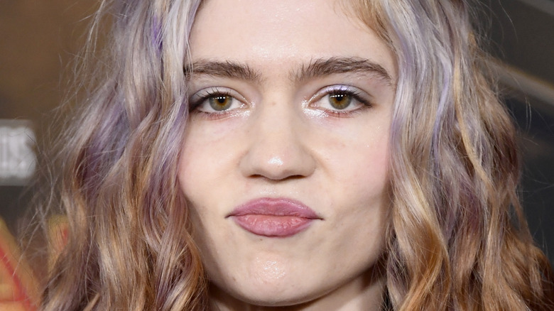 Grimes posing at a premiere