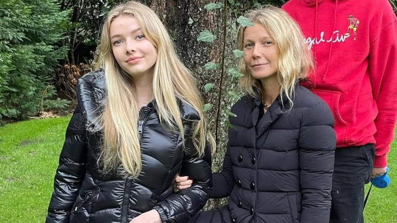 Apple Martin, Gwyneth Paltrow posing outdoors in puffer coats