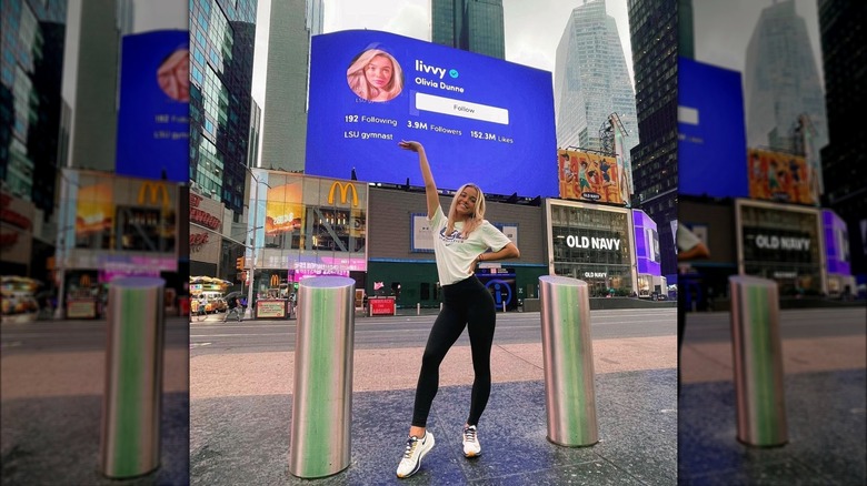 Olivia Dunne posing with billboard