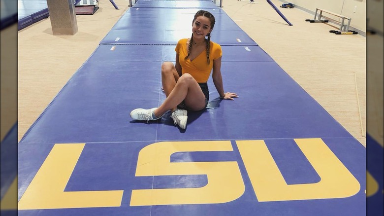 Olivia Dunne seated on LSU mat