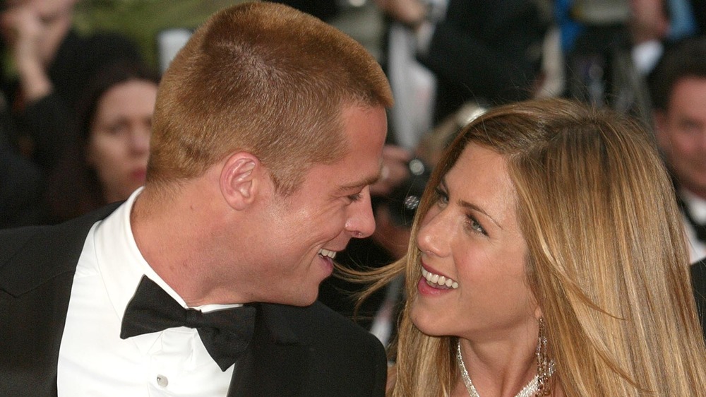 Brad Pitt and Jennifer Aniston smiling at each other