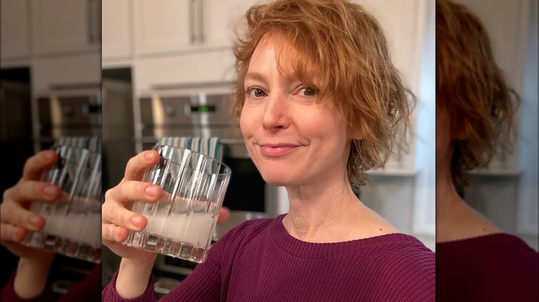 Alicia Witt drinking from a glass