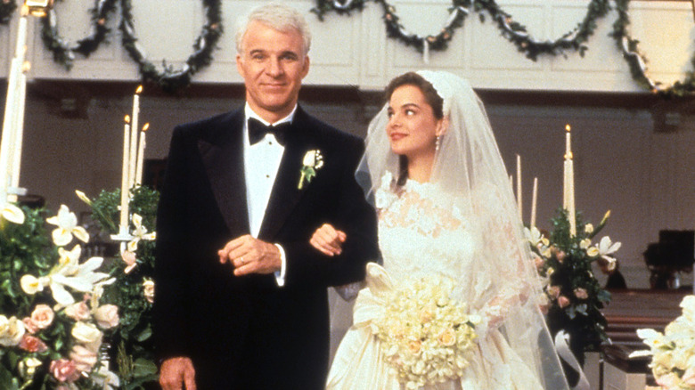 Steve Martin as George and Kimberly Williams-Paisley as Annie walking arm-in-arm in Father of the Bride