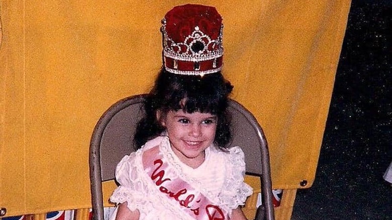 Lacey Chabert as a child, wearing a large crown at a pageant