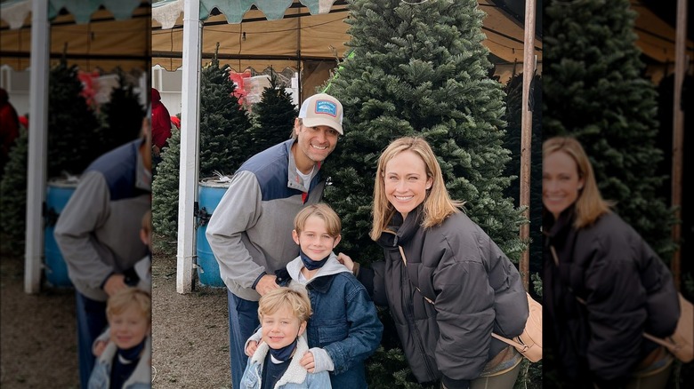 Nikki DeLoach, family posing with Christmas tree