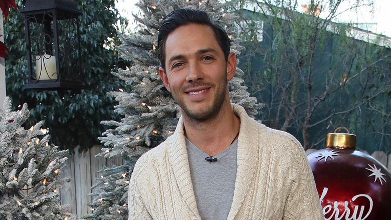 Michael Rady in front of Christmas decorations