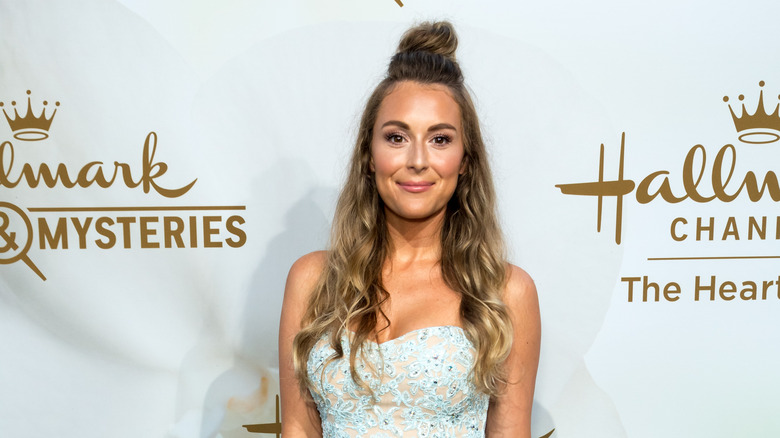 Alexa PenaVega smiling at red carpet event