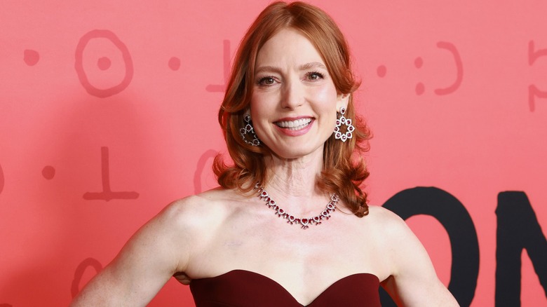 Alicia Witt smiling on red carpet