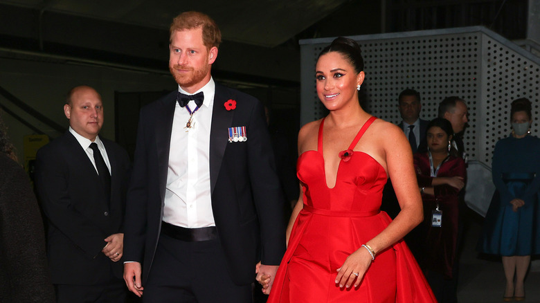 Prince Harry and Meghan Markle holding hands