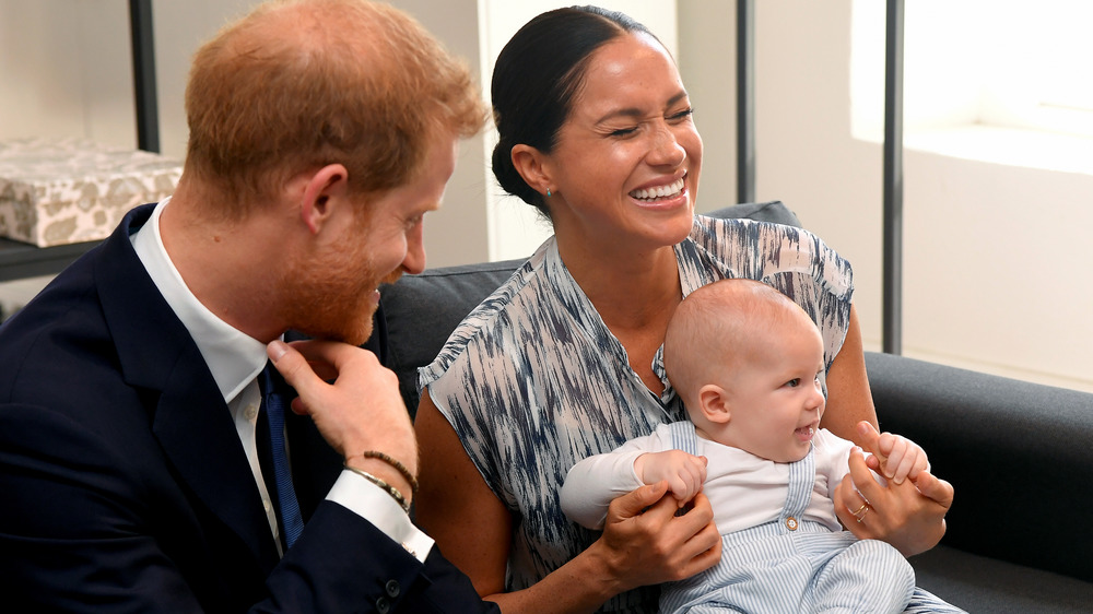 Prince Harry, Meghan Markle, and baby Archie smiling