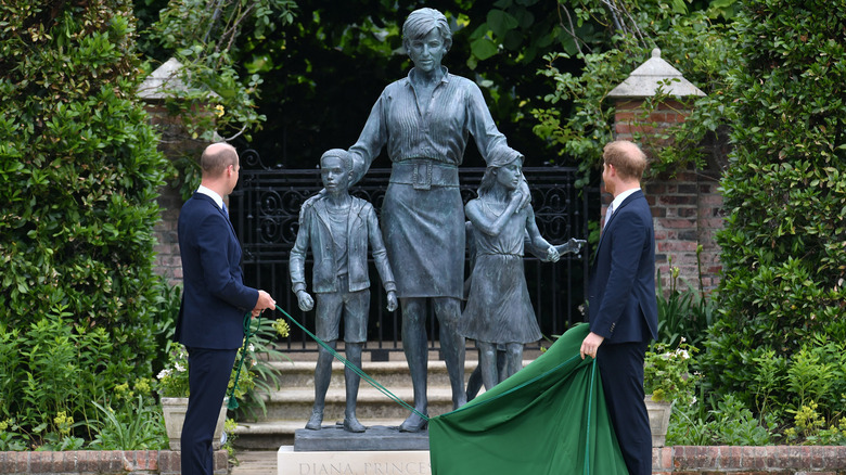 Prince William and Prince Harry in front of Princess Diana statue