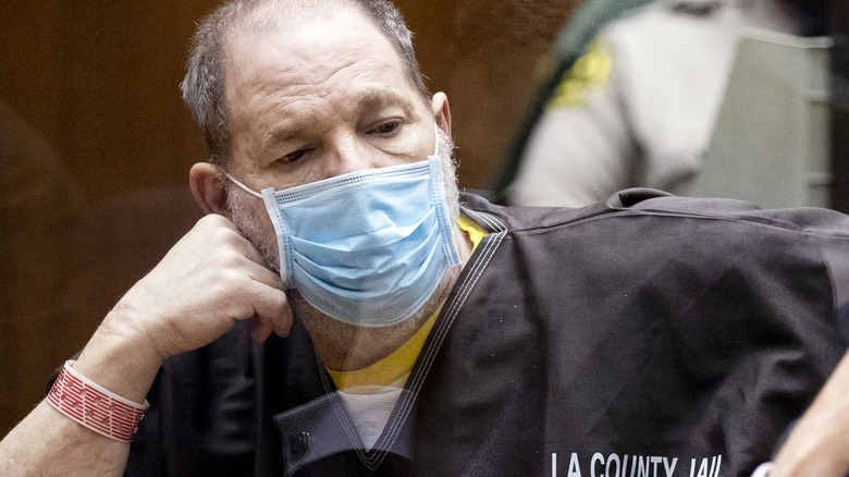 Harvey Weinstein in mask, prison clothes