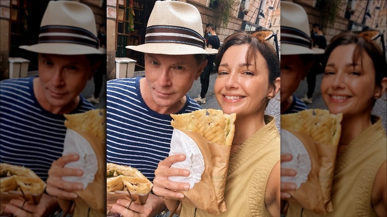Bobby Flay and Christina Pérez holding street food