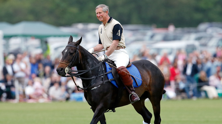 Prince Charles playing polo on a horse