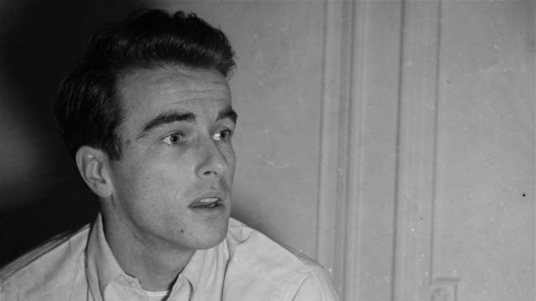 Montgomery Clift sitting against a wall
