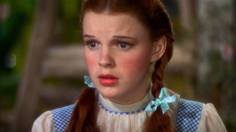 Judy Garland as Dorothy in The Wizard of Oz looking concerned