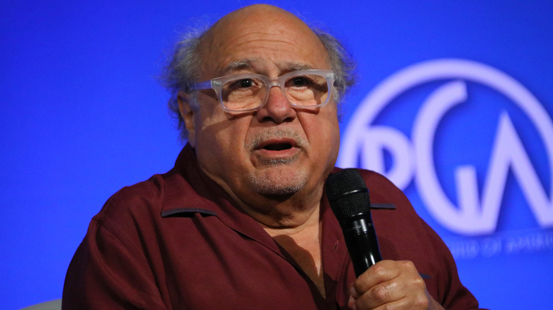 Danny DeVito speaking into mic