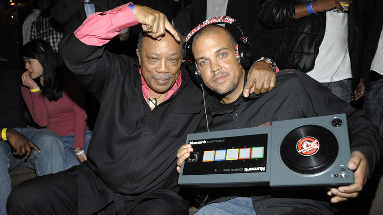 Quincy Jones and Quincy Jones III holding DJ equipment