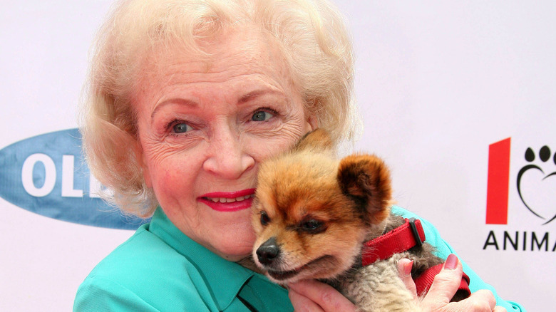 Betty White holding a puppy 