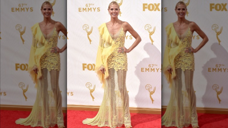 Heidi Klum wearing yellow semi-sheer dress