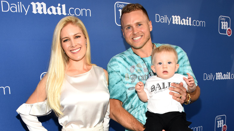 Heidi Montag smiling and Spencer Pratt smiling and holding their son, Gunner