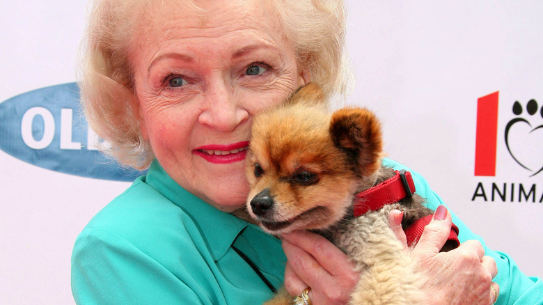 Betty White posing with a dog 