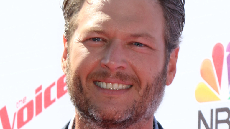 Blake Shelton smiles at an event