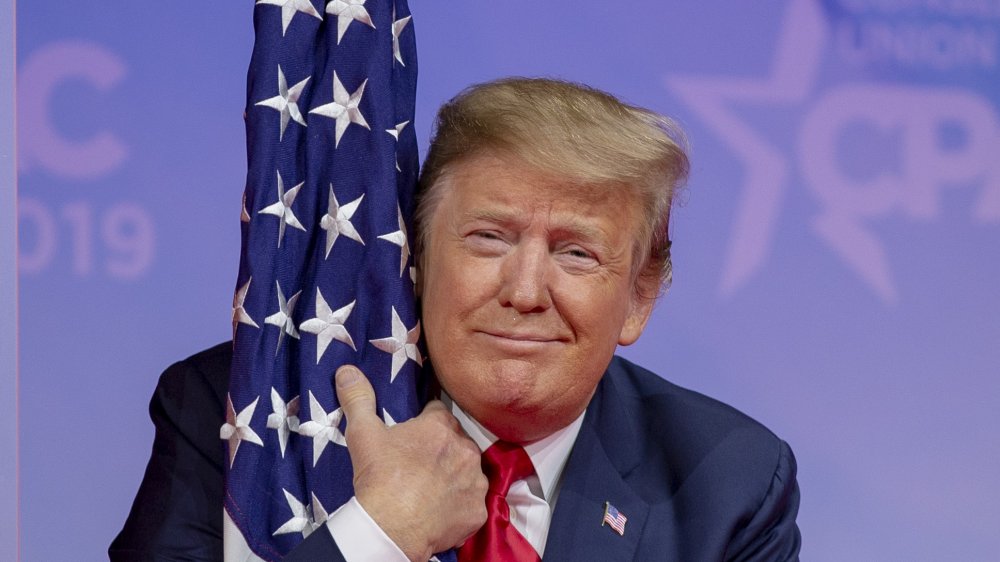 Donald Trump hugging the American flag