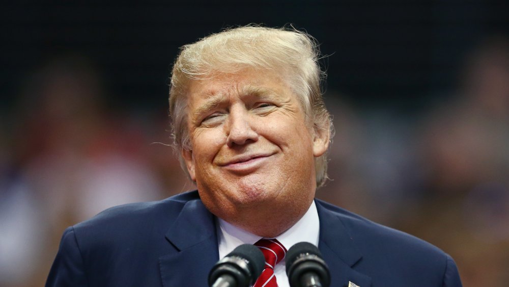 Donald Trump smirking at a podium