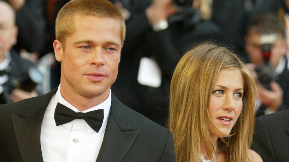 Brad Pitt and Jennifer Aniston posing at a movie premiere