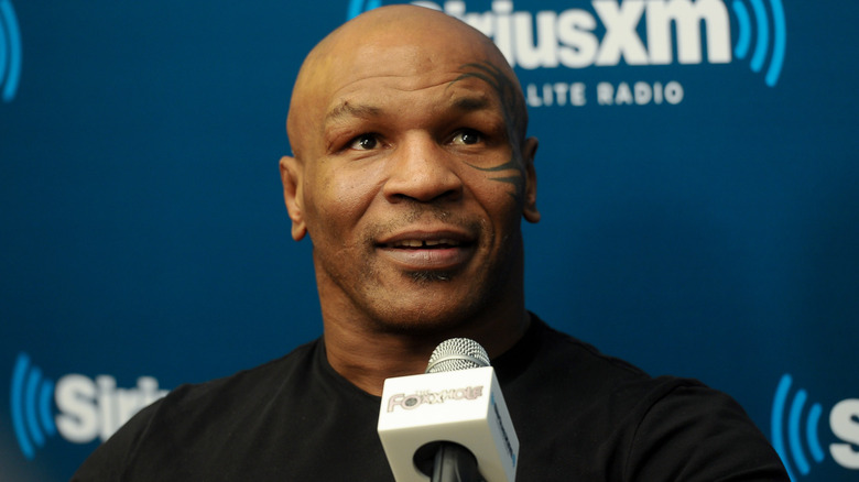 Mike Tyson speaks into a microphone