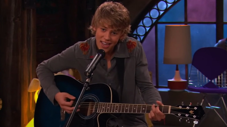 Austin Butler with guitar and microphone