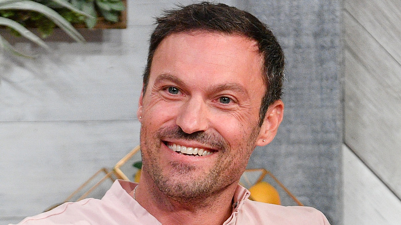 Brian Austin Green wearing a pink shirt