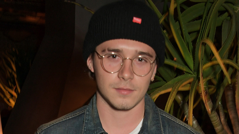 Brooklyn Beckham, wearing glasses and a hat in 2019