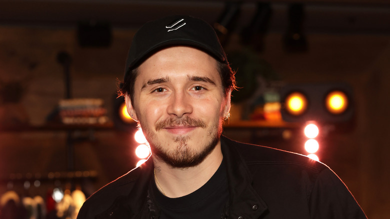 Brooklyn Beckham, smiling with a goatee, 2021 photo