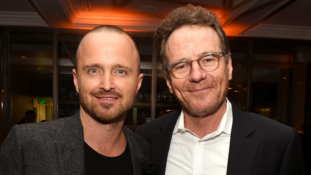 Bryan Cranston and Aaron Paul smiling at an event