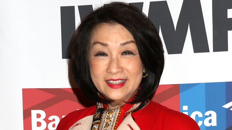 Connie Chung wearing a red jacket