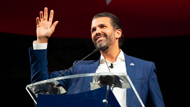 Donald Trump Jr. waving at podium