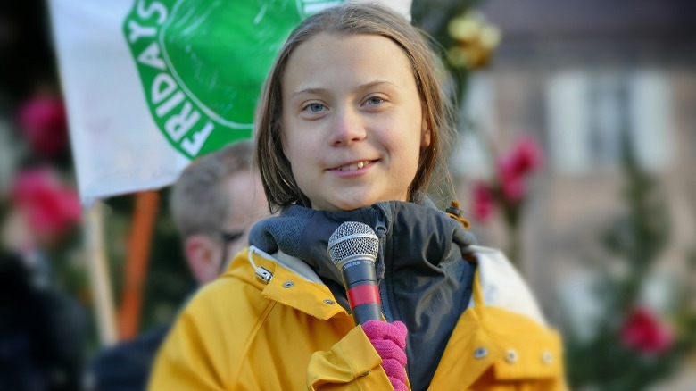 Greta Thunberg smiling at protest