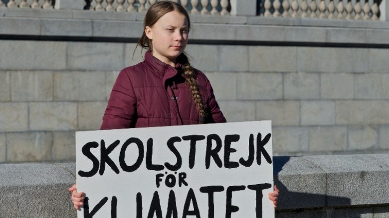 Greta Thunberg with protest sign